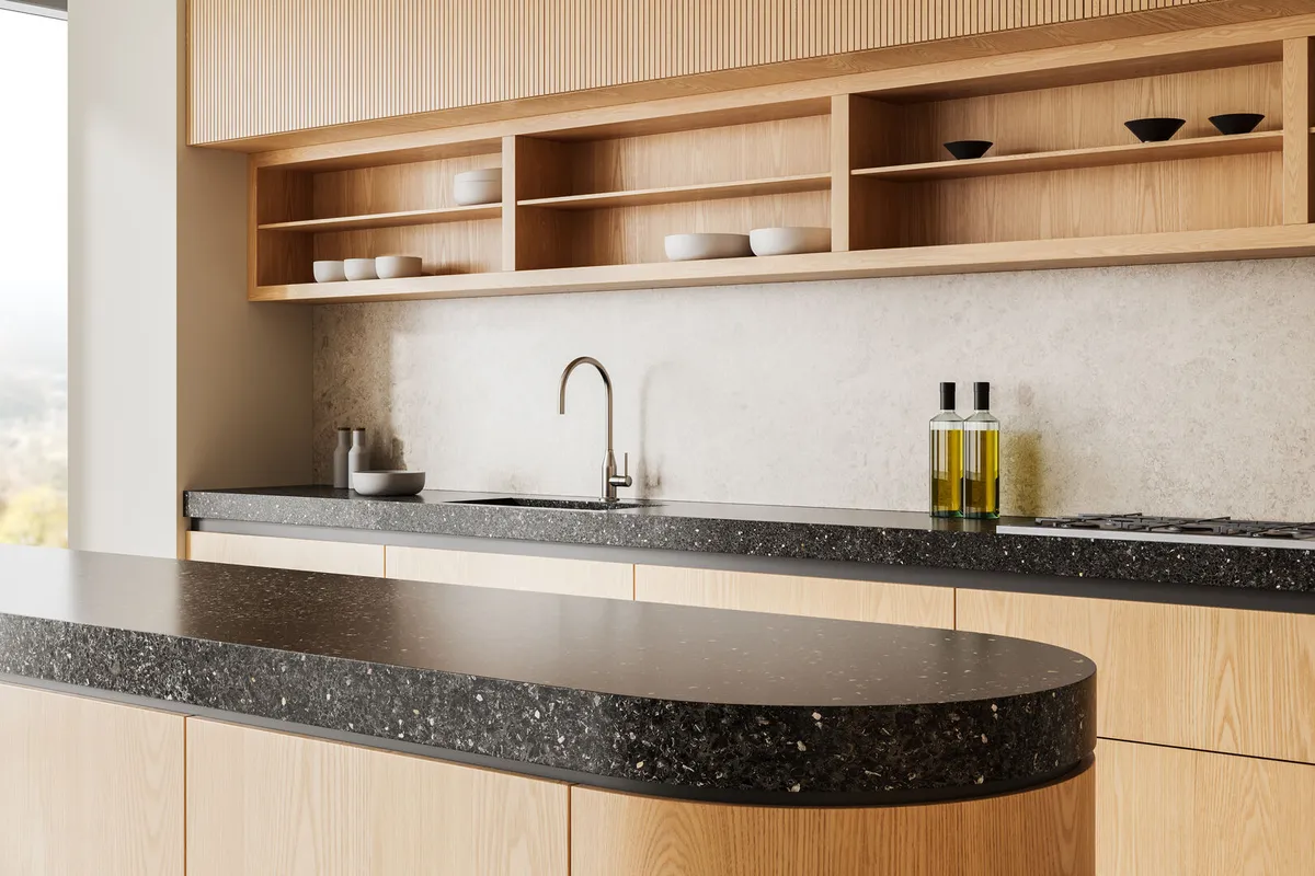 Modern minimalist kitchen interior with wooden cabinetry and terrazzo countertops
