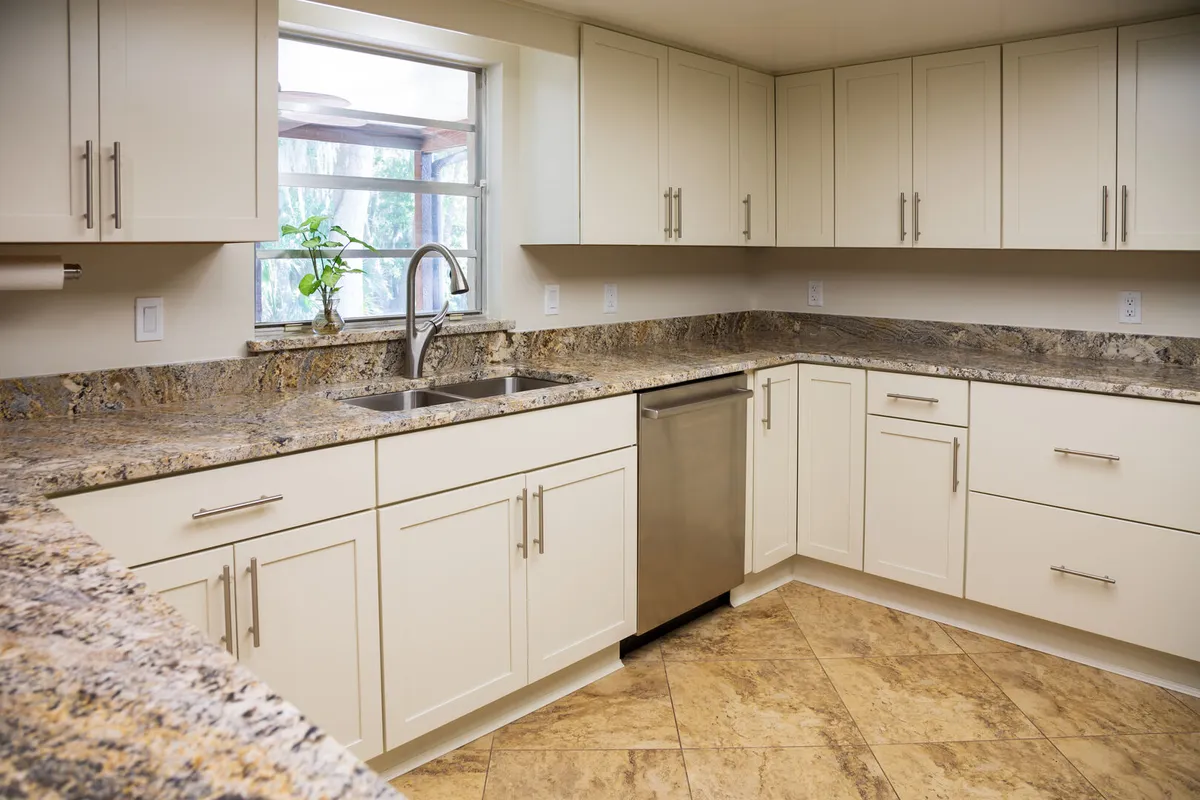 Modern U-Shaped Kitchen with White Cabinets, Granite Countertops