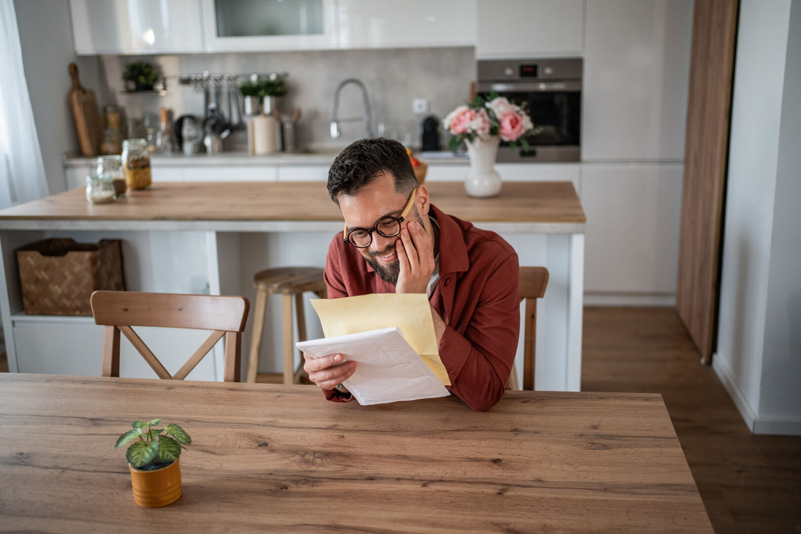 Single-Wall Kitchen with Happy man receiving good news opening mail