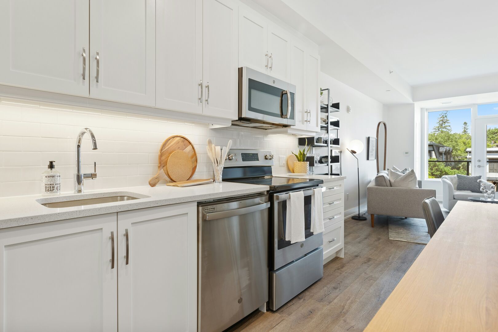 Modern white galley kitchen design with stainless steel appliances