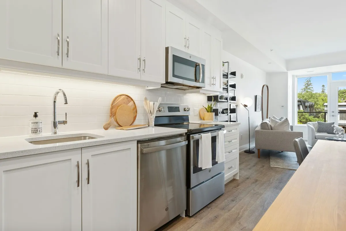 Modern white galley kitchen design with stainless steel appliances