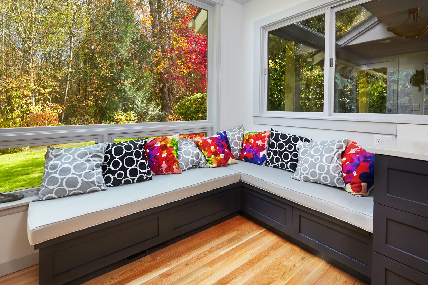 L-shaped kitchen window seat in black with colourful pillows