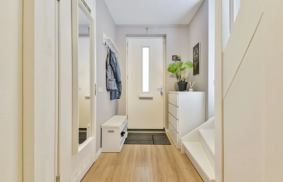Hallway interior with white walls and wooden floors