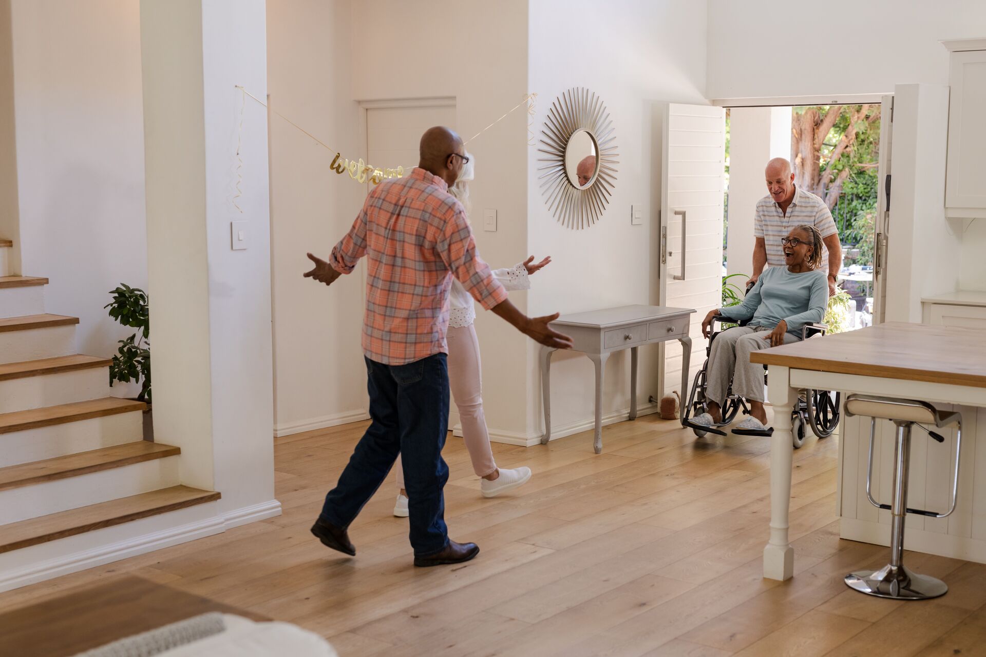 Family Welcoming Senior Woman Home in Wheelchair