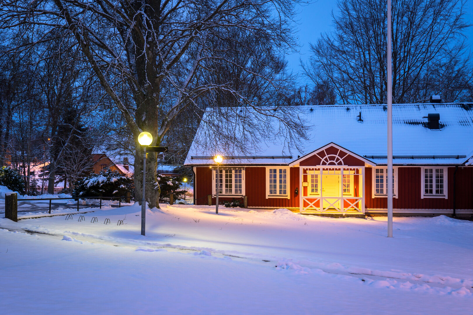 Winter scenery with red wooden house in Sweden at night