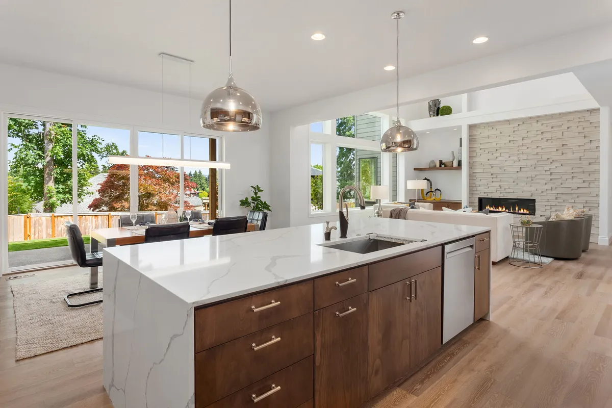 Beautiful kitchen and living room in new modern luxury home with open concept floor plan