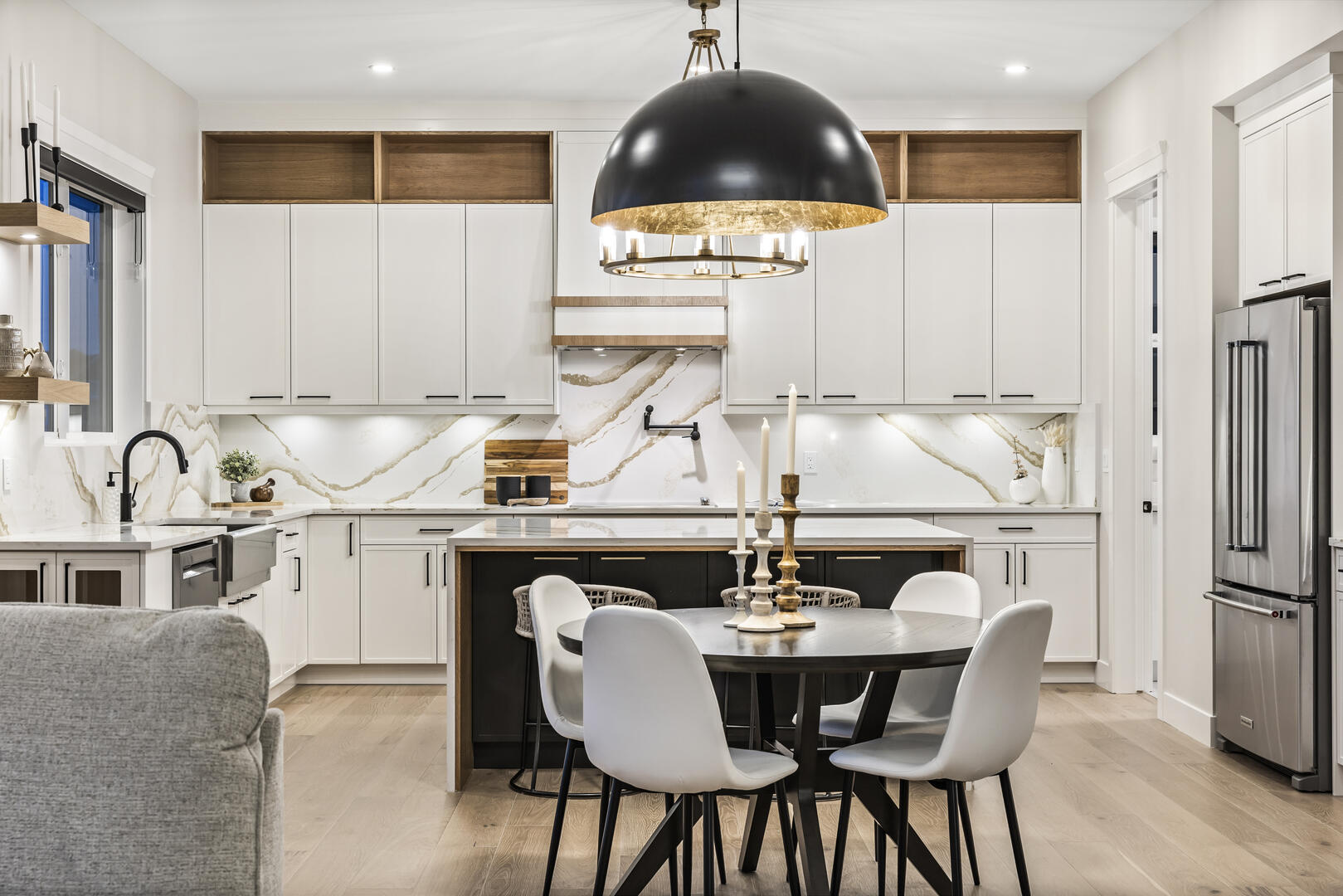 Large modern luxury kitchen with white cabinets and black pulls