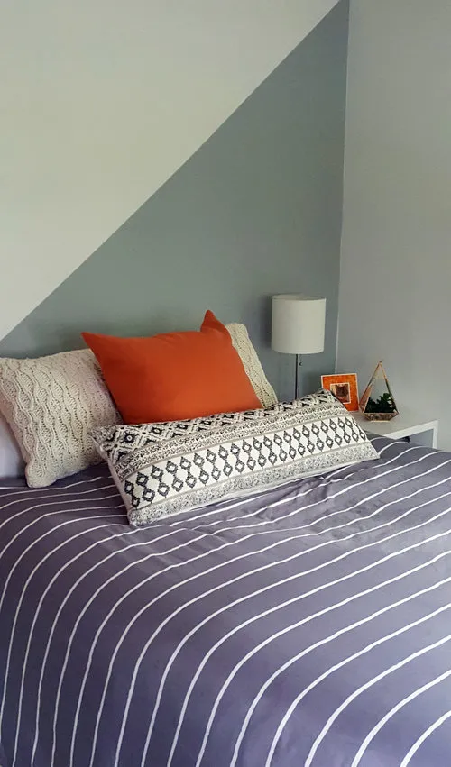 Cozy bedroom with feature wall with colours angles intersecting