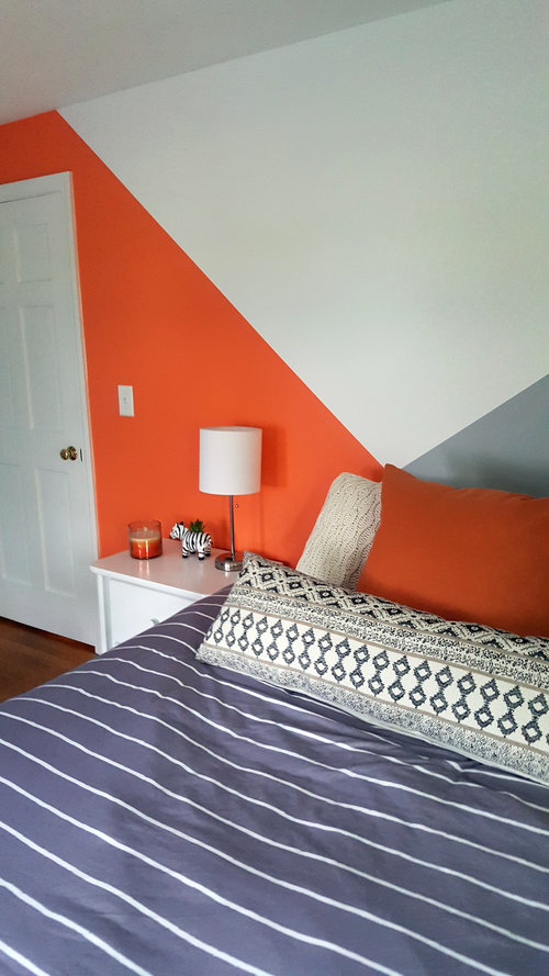 Cozy bedroom with feature wall with colours angles intersecting