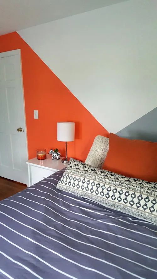 Cozy bedroom with feature wall with colours angles intersecting