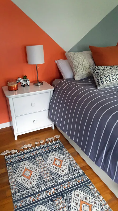 Cozy bedroom with feature wall with colours angles intersecting