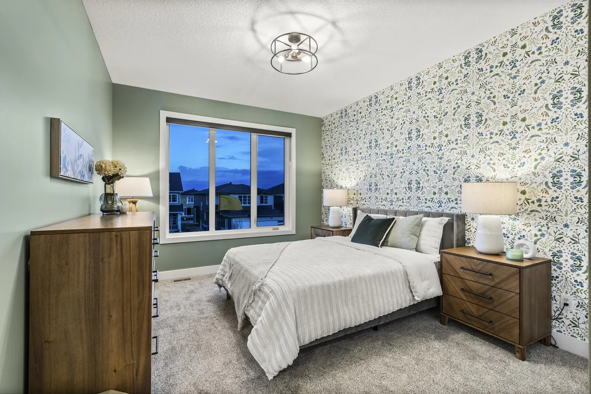 Green bedroom with floral wallpaper and wood furniture