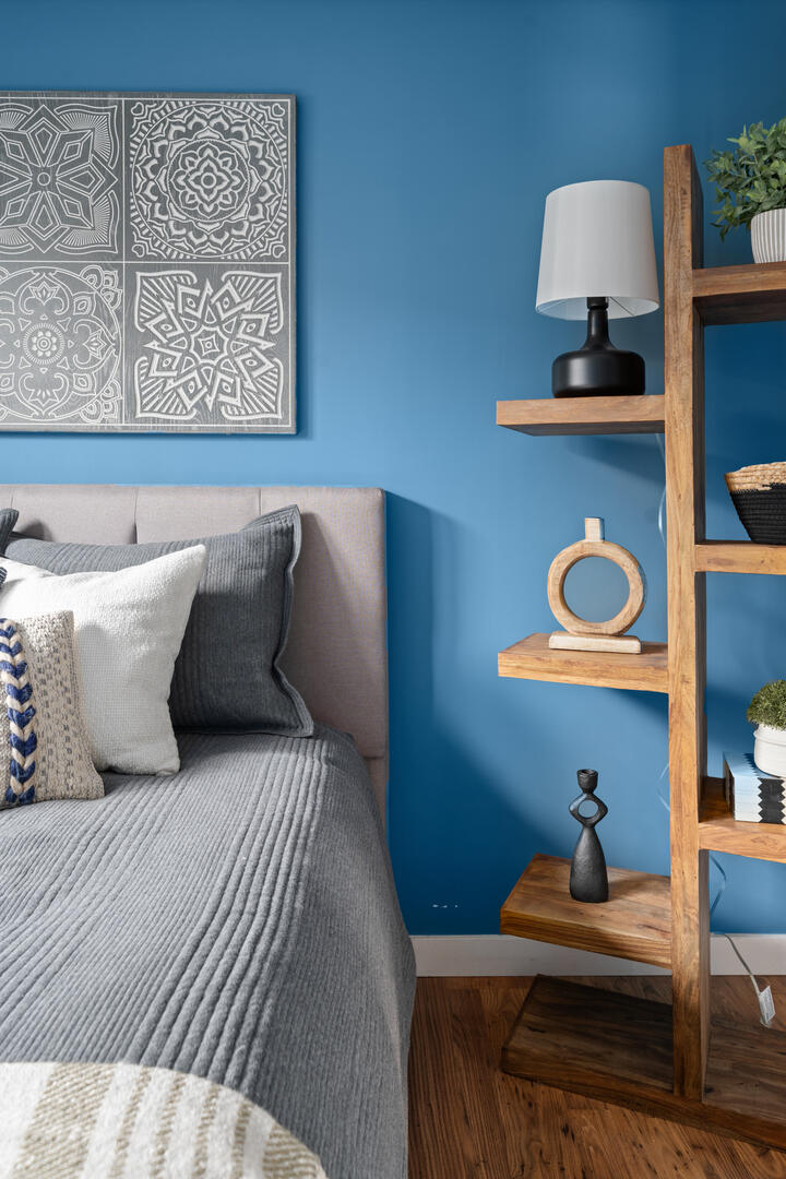 Guest bedroom with large open bookshelves