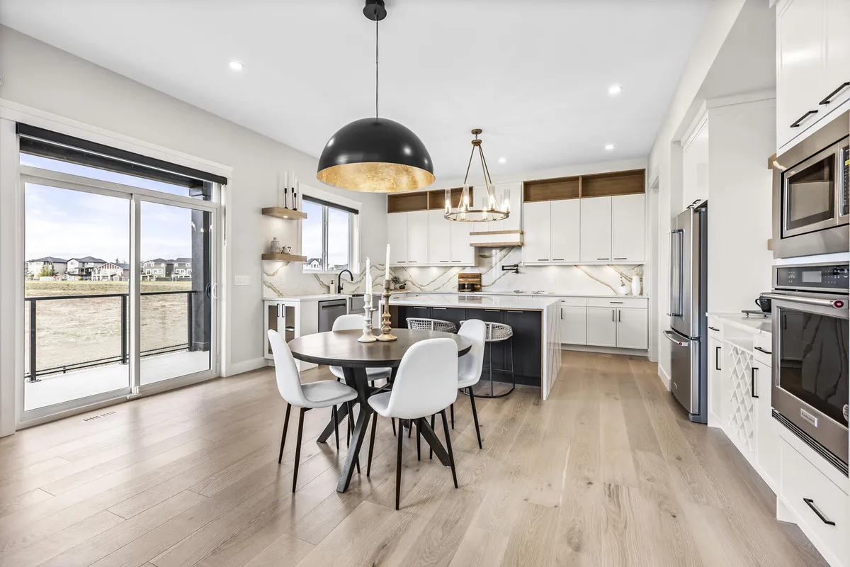 Large modern luxury kitchen with white cabinets and black pulls