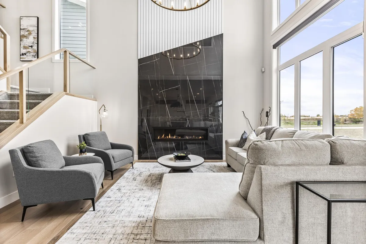 two story fireplace feature wall living room in front of large picture windows