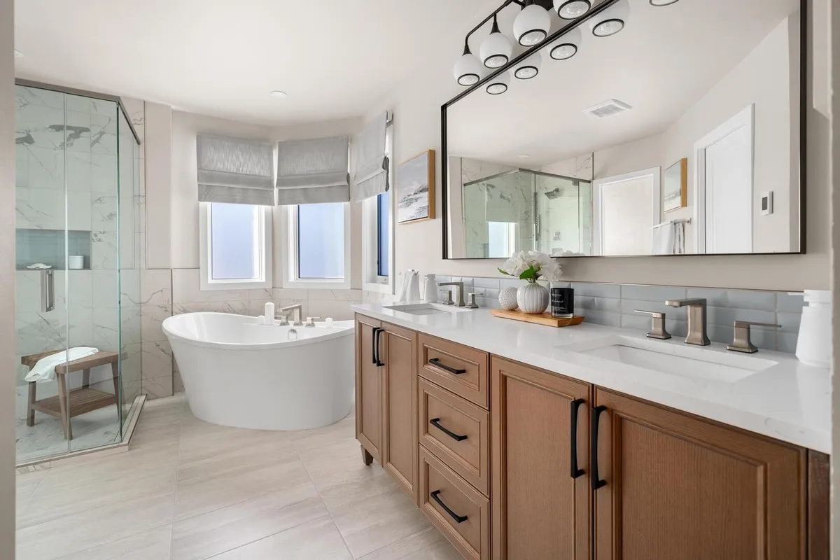 Large bright modern bathroom with soaker tub and walk in glass shower