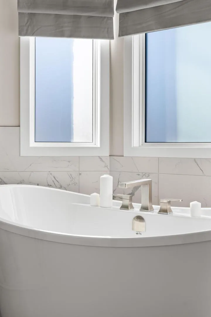 Closeup of a large white modern standalone soaker tub