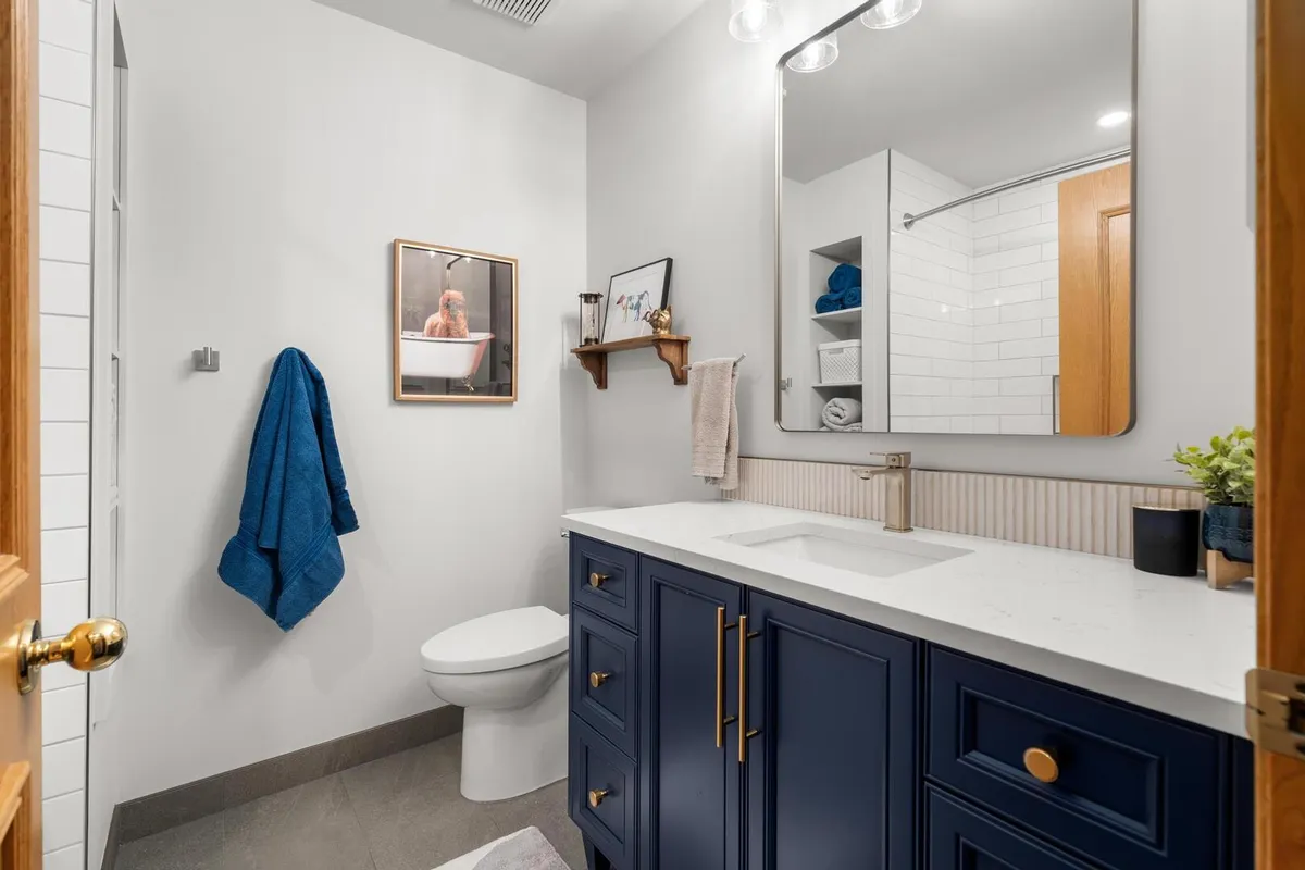 Bright and fresh guest bathroom with blue cabinets