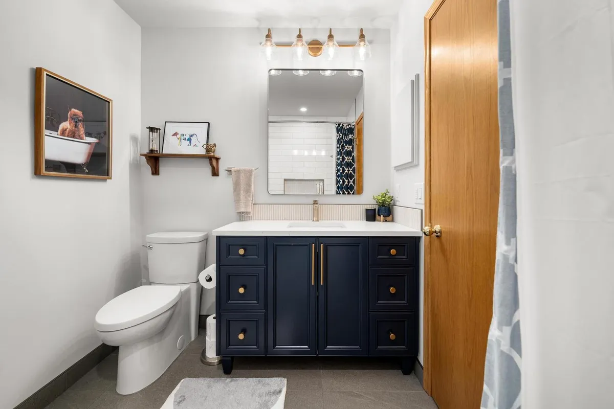 Modern bathroom with blue cabinet vanity