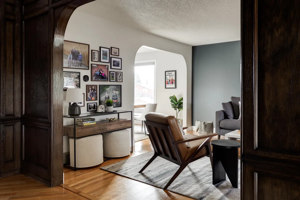 Dark arch entryway into modern white and blue living room