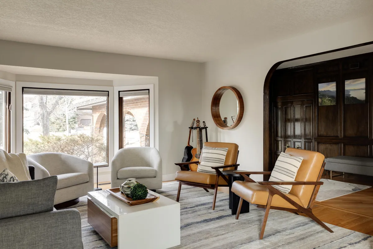 Blue and white living room with wood accents and bay window seating area