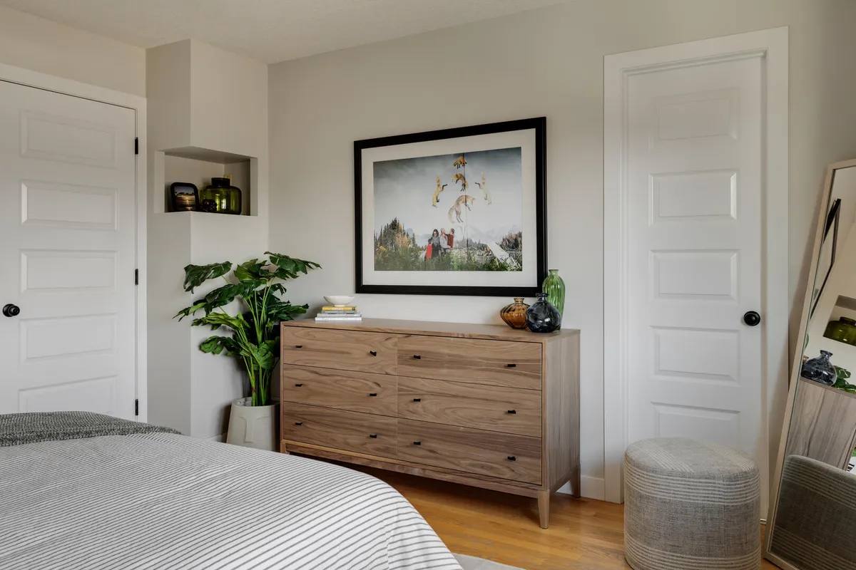 Modern light and bright bedroom with plant and wood furniture
