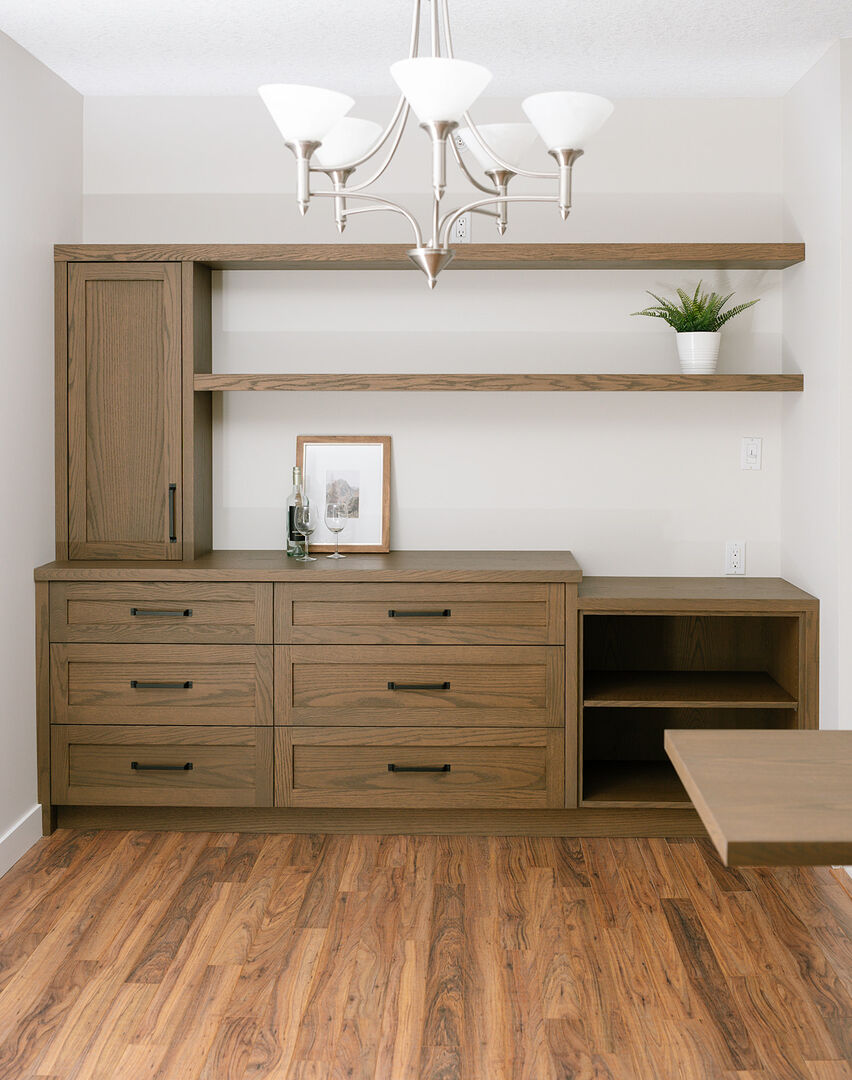 Custom walnut built-ins with lower counter for accessible dining room storage.
