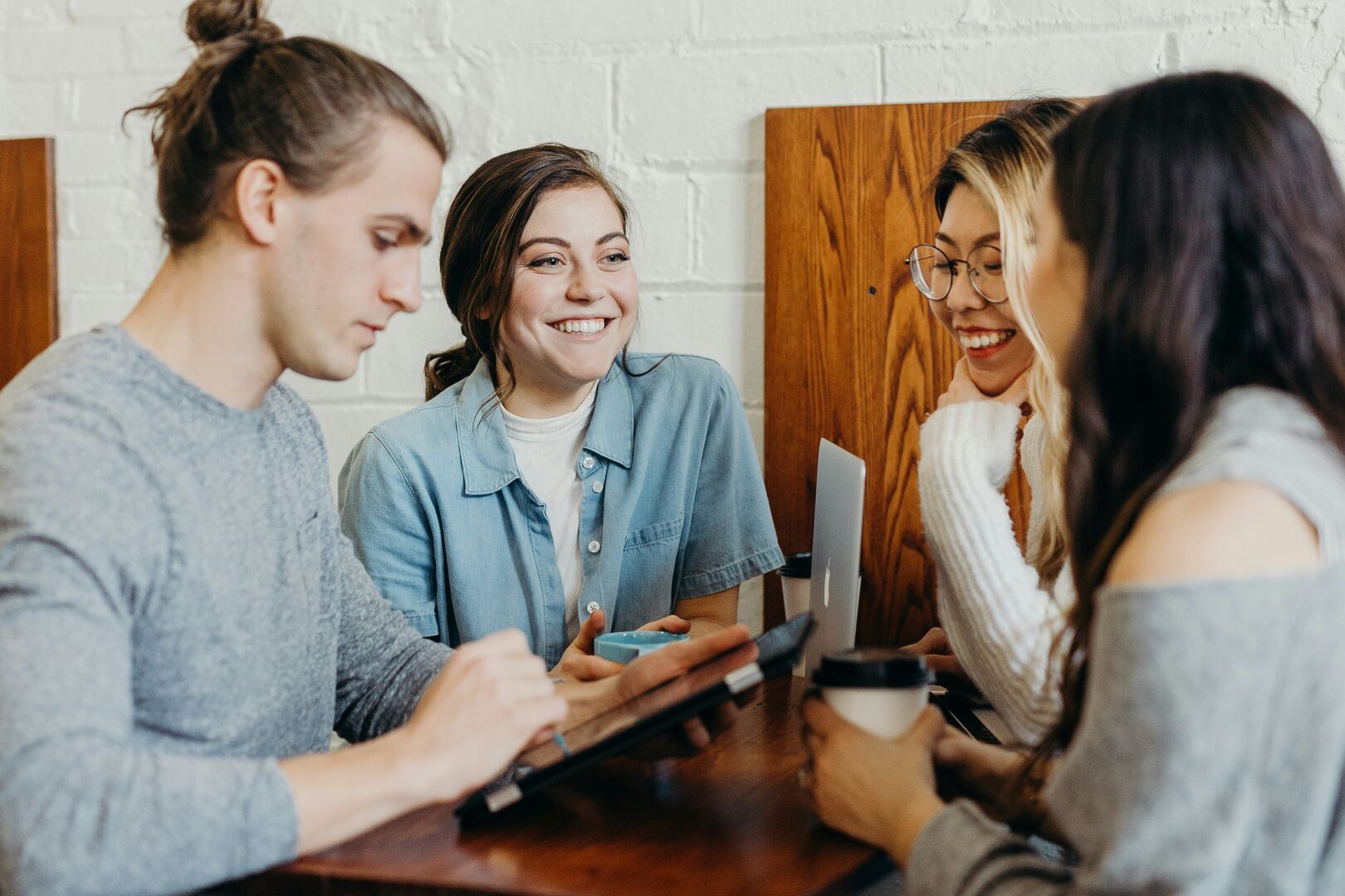 A group of colleague’s collaborating over a project in a cafe.