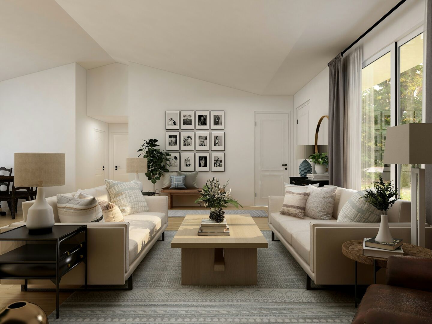 Neutral living room with two sofas, black and white photos and layered window treatments