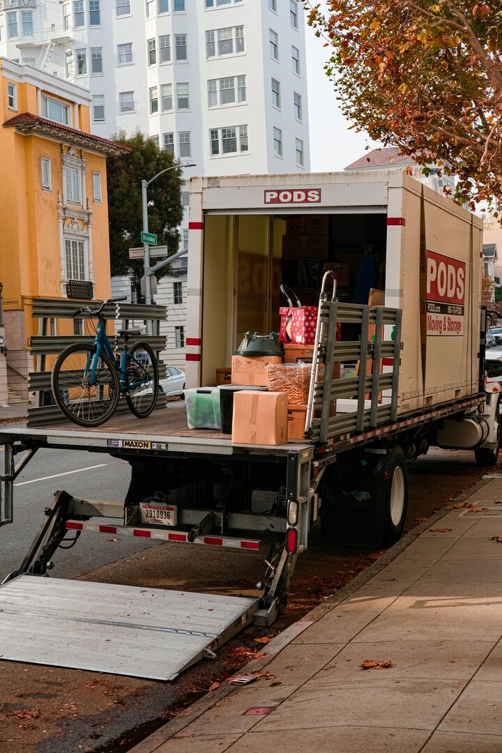 Furniture and household items being moved and packed into a moving truck.