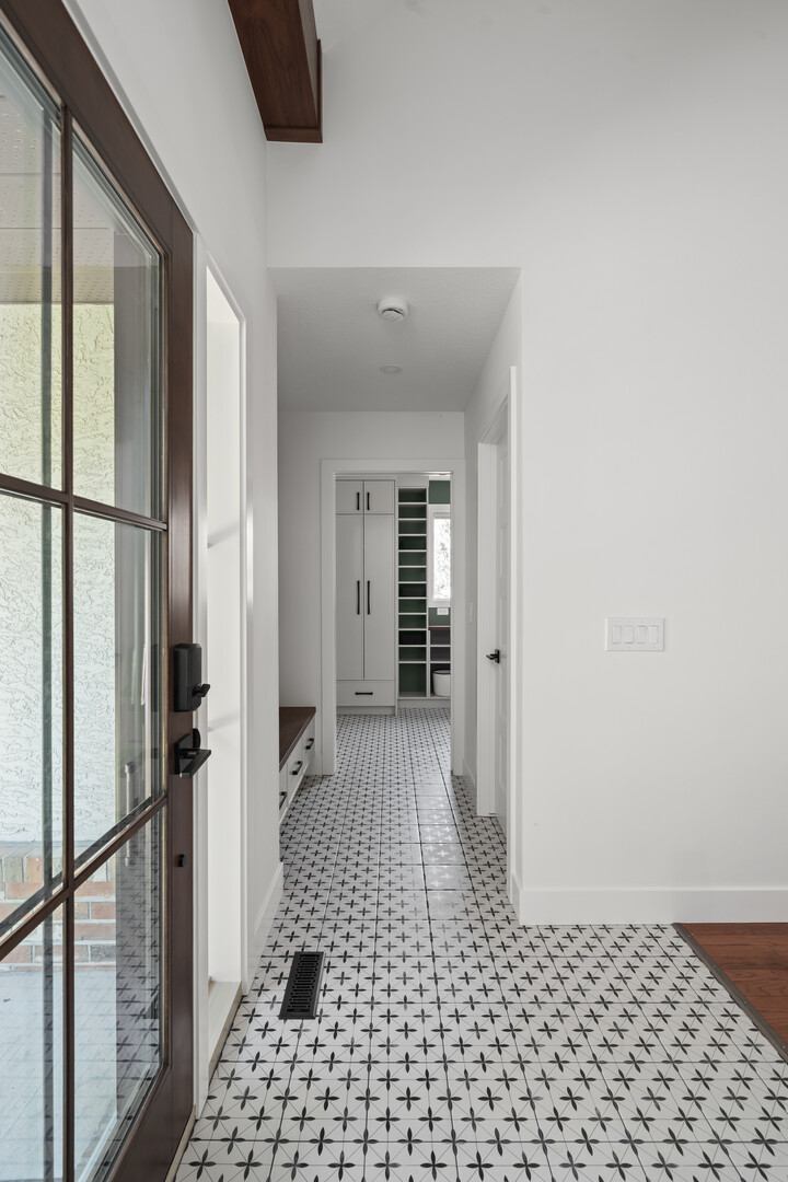 Modern home office with geometric rug and wallpaper feature wall