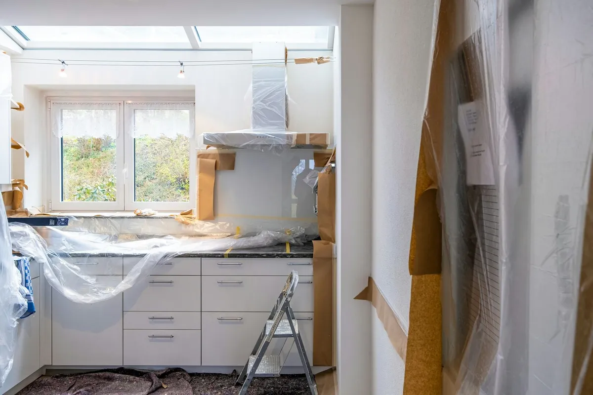 Kitchen renovation with white cabinets and black countertops