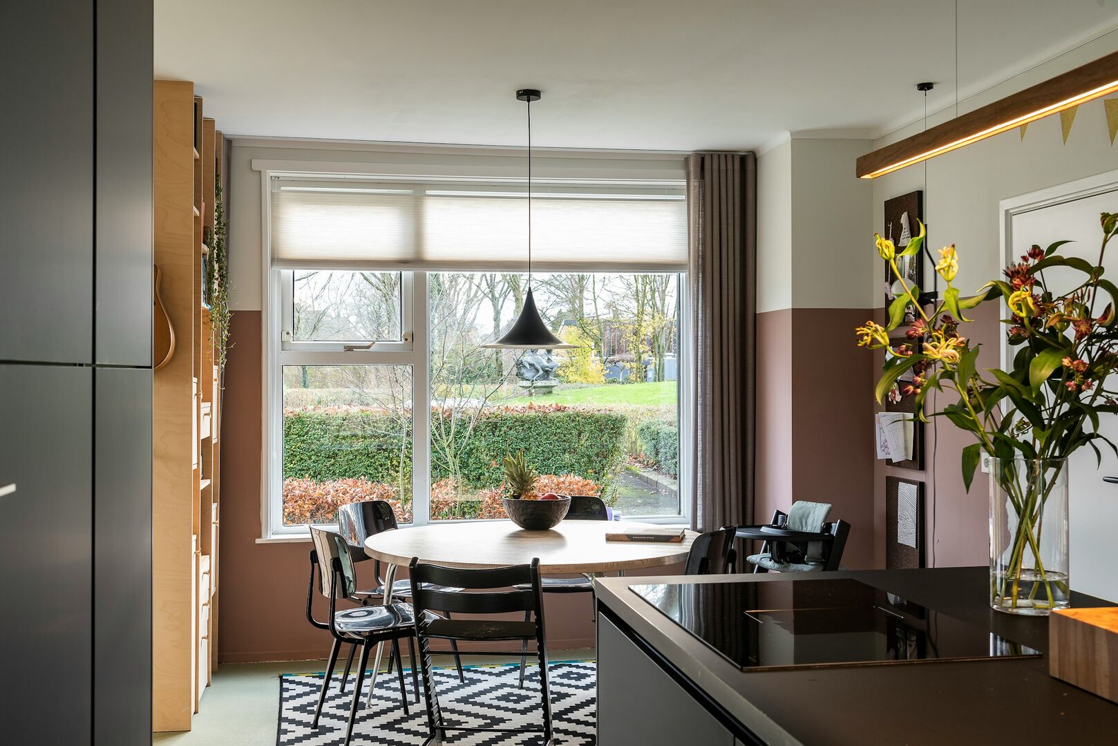 Eat in kitchen with dark cabinetry and countertops