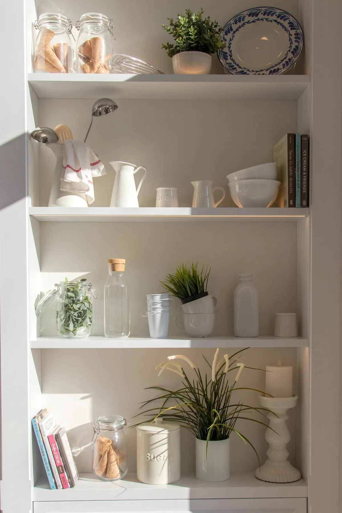 Light bright shelf with jars, bowls, and plates