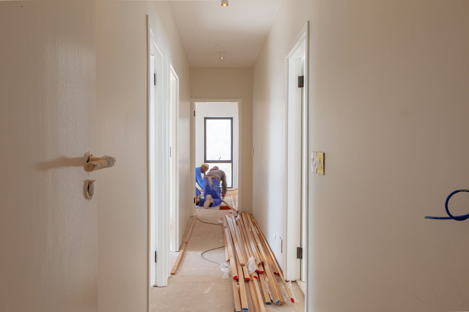 Two contractors working and renovating a main floor of a detached house