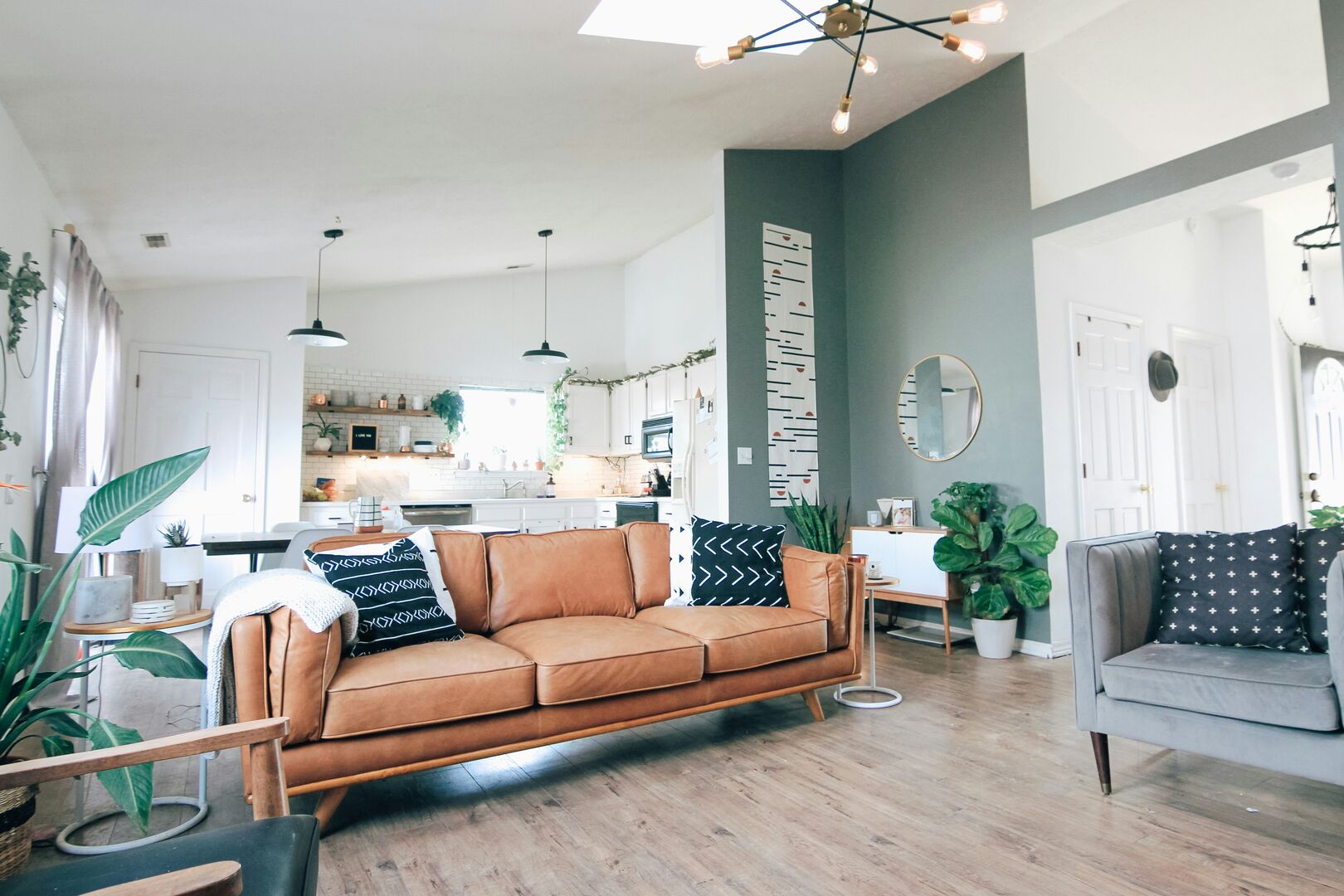 Mid century modern living room with a leather sofa and black throw cushions