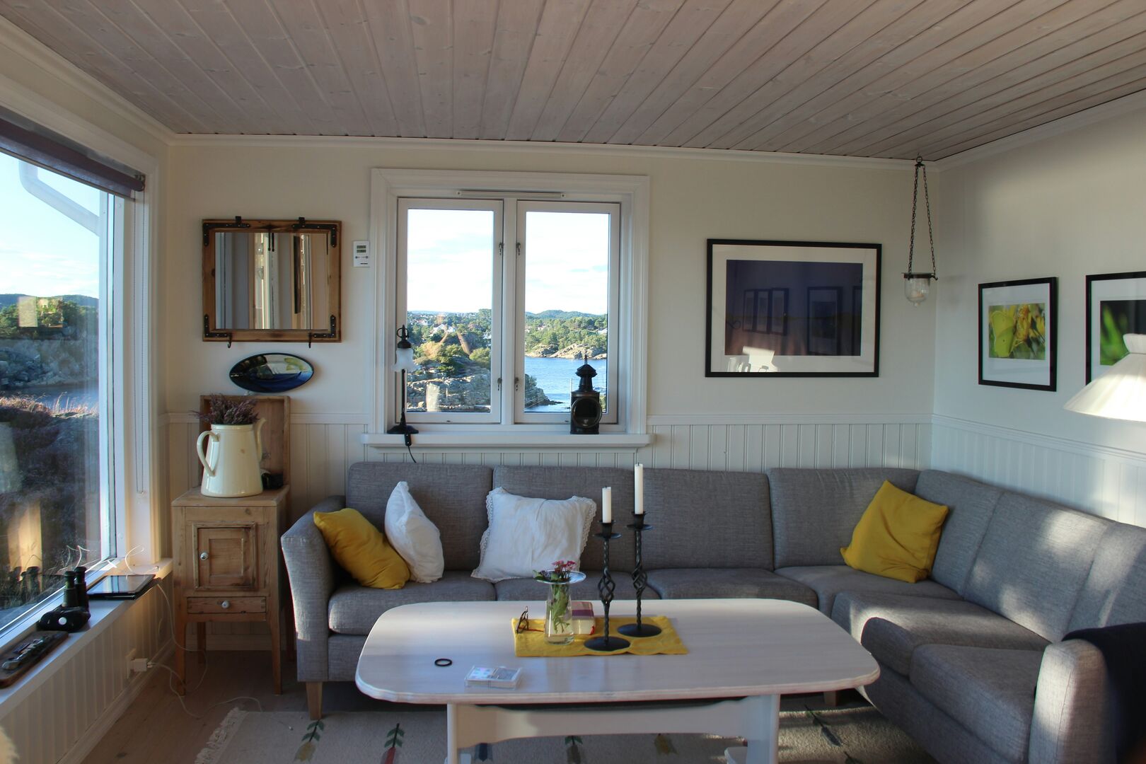 Grey sectional in white living room, tiny home cottage on the ocean