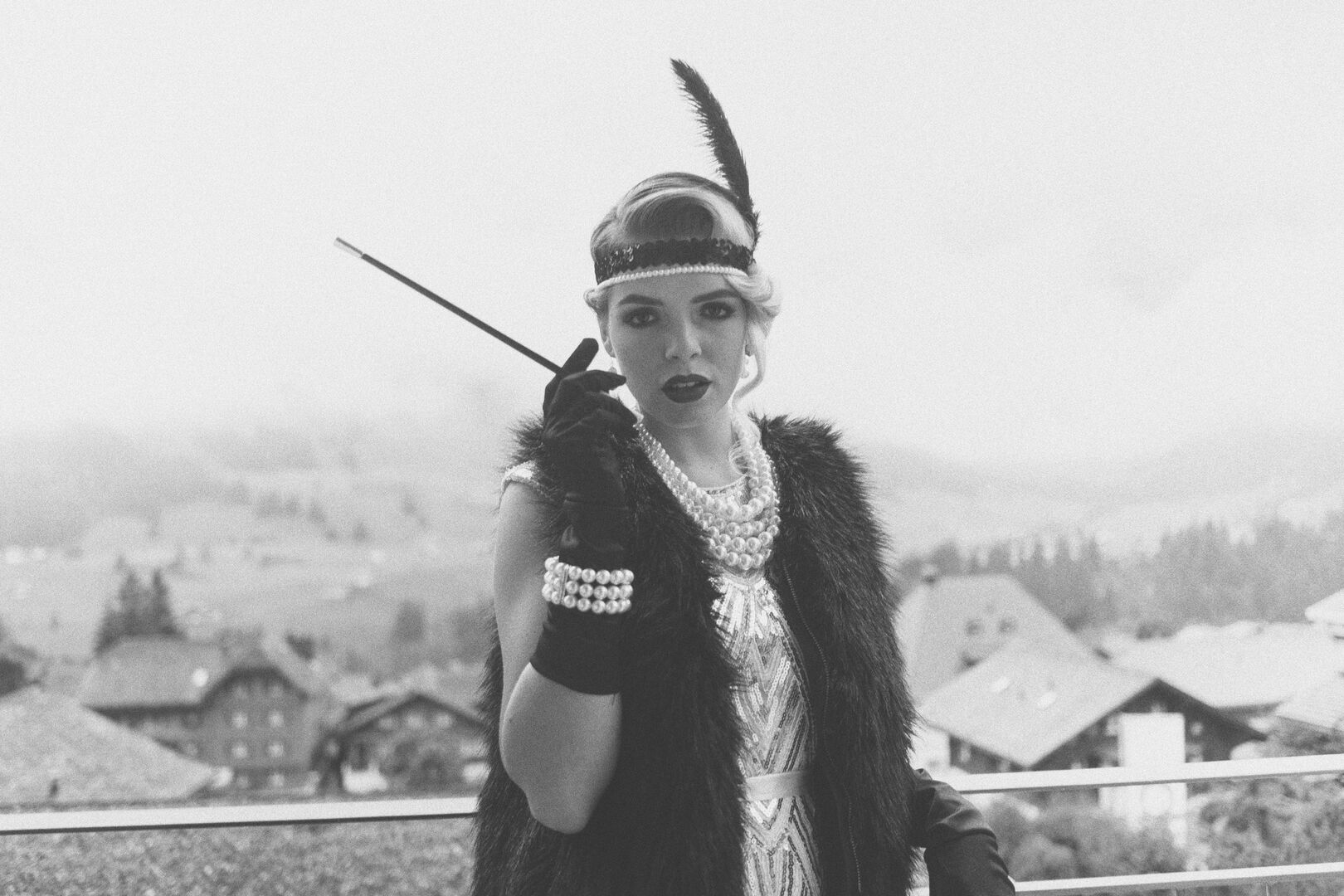 Women dressed up like a character from Gatsby wearing pearl jewellery.