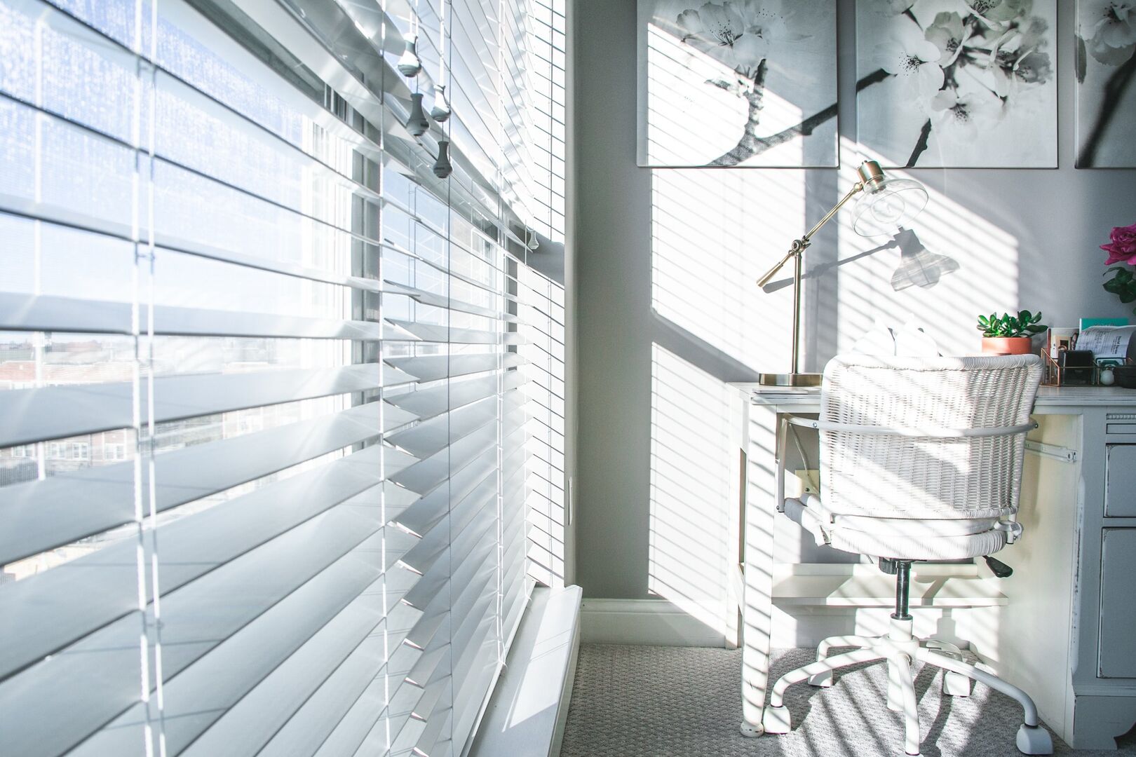 Closeup photo of window blinds with light shining through