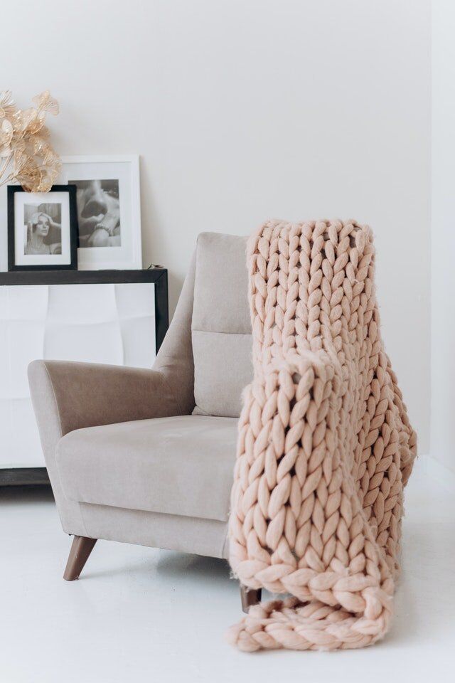 Modern wingback chair with large knit blanket