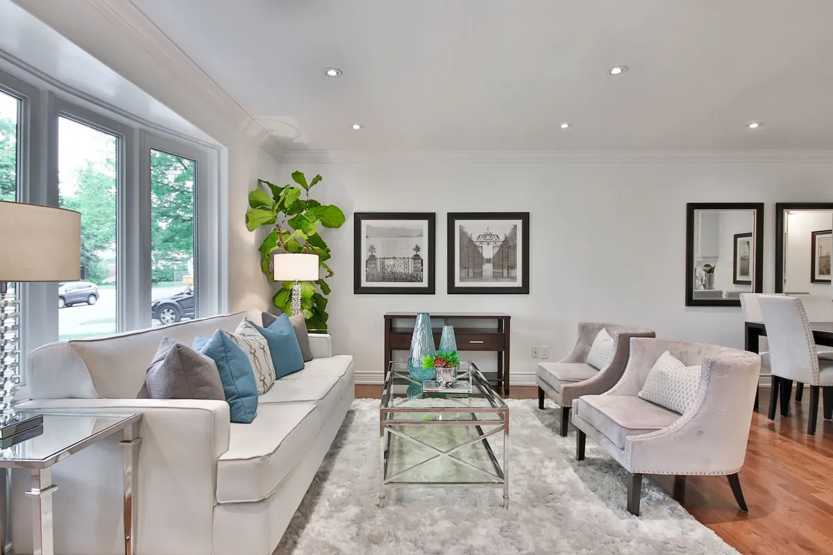 Transitional living room with grey and blue color scheme and chrome accents