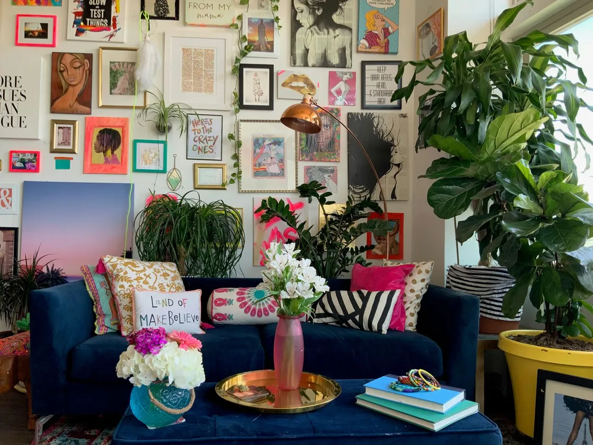 Modern maximalist living room with navy blue sofa and eclectic gallery wall